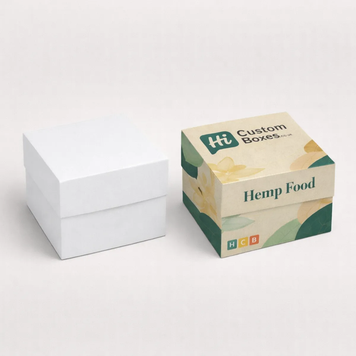 Two-piece rigid gift boxes with lids- showing a minimalist white version beside a branded botanical-print box- class=